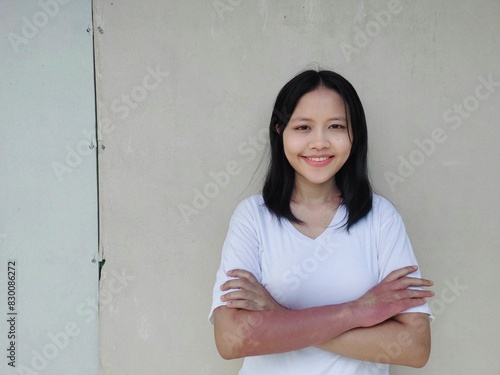 Portrait of Confident young asian woman in white casual clothing, smiling, cheerful with arms folded, isolated, Beautiful positive businesswoman standing, looking at camera against grey background