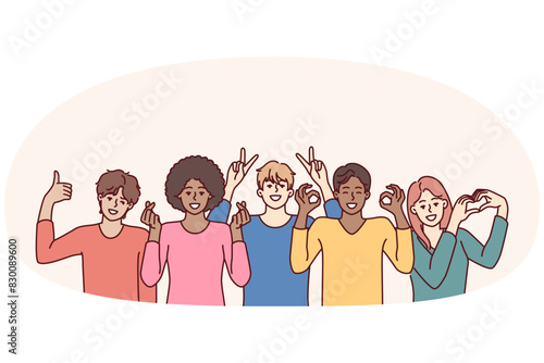 Team of diverse people of different genders and ages or nationalities pose together for group shot. Multiracial people working or studying in same team smiling and showing friendly gestures
