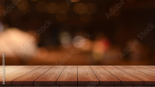 Empty wooden table top with lights bokeh on blur restaurant background.