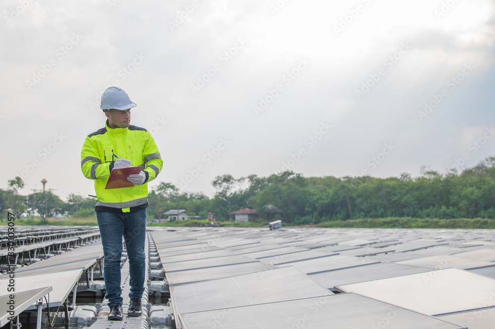 Engineer working at floating solar farm,checking and maintenance with solar batteries near solar panels,supervisor Check the system at the solar power station Engineer working at floating solar farm,checking and maintenance with solar batteries near solar panels,supervisor Check the system at the solar power station
