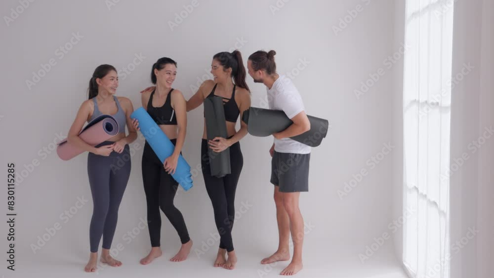 Group Yoga Class Participants with Mats in a Bright Studio Group Yoga Class Participants with Mats in a Bright Studio