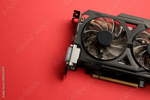 One graphics card on red background, top view. Space for text