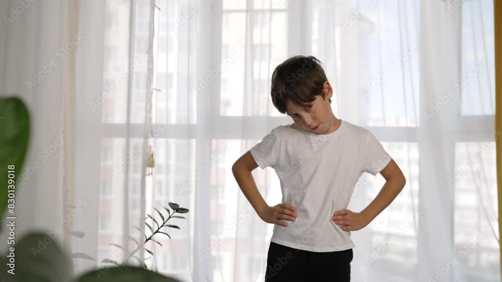 Morning exercise program that the child does. The boy plays sports at home. A boy does exercises at home before going to school. Morning exercise program that the child does. The boy plays sports at home. A boy does exercises at home before going to school.