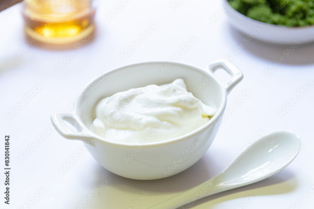 Greek yogurt and wolffia globosa in ceramic bowl isolated on white table background. Wolffia is the nutrient-rich plant-based source of protein and omega3 and vital minerals. Healthy and easy meal. Greek yogurt and wolffia globosa in ceramic bowl isolated on white table background. Wolffia is the nutrient-rich plant-based source of protein and omega3 and vital minerals. Healthy and easy meal.