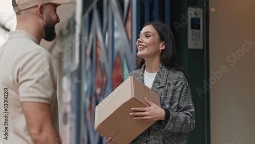 A doorstep exchange as a customer receives a package from a delivery man, capturing the convenience of home delivery services and the satisfaction of receiving an order.