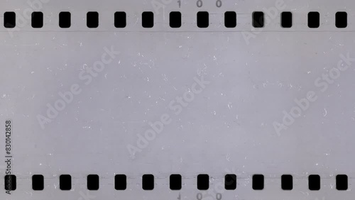 Old celluloid film strip with dust and scratches, 4K retro background