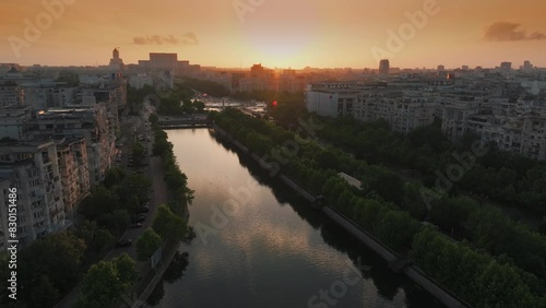 Sunset over Bucharest. Aerial drone 4k video view over Unirii Square, Boulevard and Palace of the Parliament from Bucharest, summer sunset sky landscape photo. Travel to Romania. photo