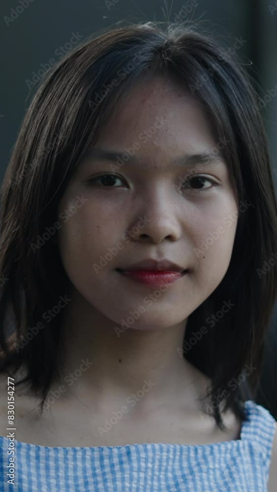 soom in close up of the face of a young asian teenager girl smiling and happy looking at camera next to the garden wearing tank top soom in close up of the face of a young asian teenager girl smiling and happy looking at camera next to the garden wearing tank top