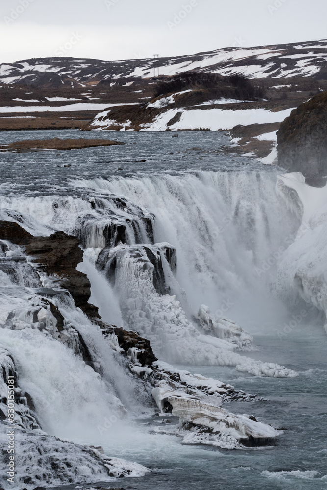 Majestic frozen waterfall in Iceland rough landscape Majestic frozen waterfall in Iceland rough landscape