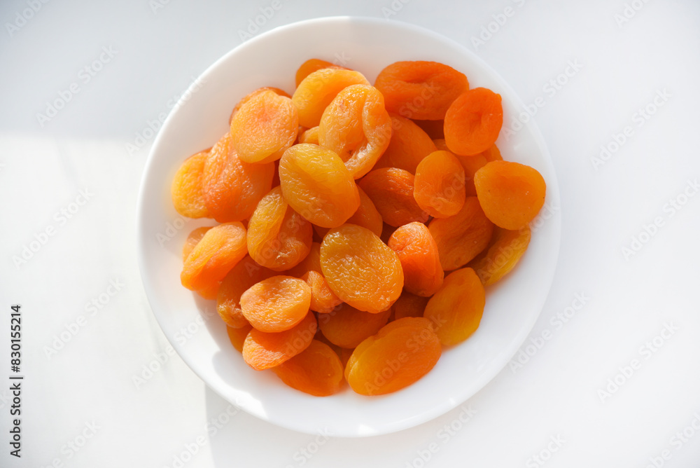 Dried fruits. Dried apricots. Dried apricots in close-up on a white plate. Dried fruits. Dried apricots. Dried apricots in close-up on a white plate.