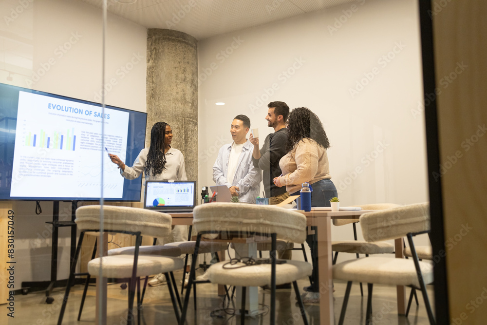 Diverse Team Discussing Business Strategy in Coworking Space Diverse Team Discussing Business Strategy in Coworking Space