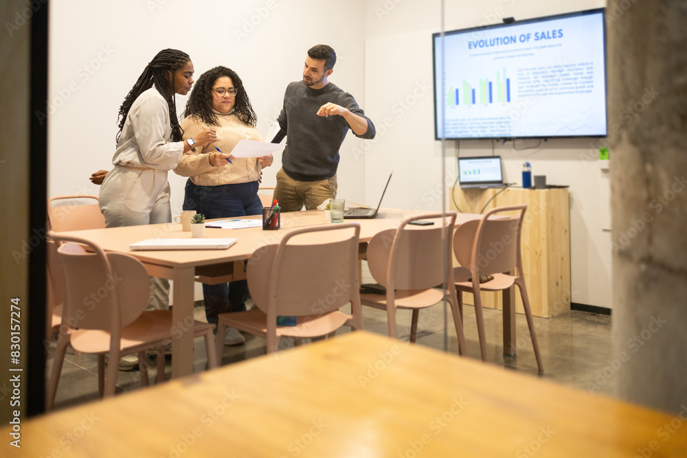 Collaborative Team Reviewing Data in Modern Office Space Collaborative Team Reviewing Data in Modern Office Space