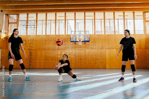 Woman volleyball player receiving a ball with a bump while training