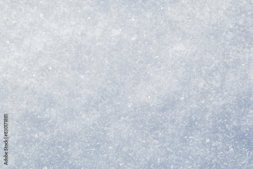 Close-up of fresh and bright snowy land in the winter, viewed from above. Abstract full frame textured background with copy space. Top view.