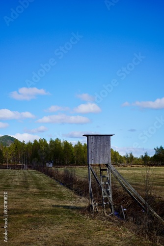 Hunting towers overlooking a field by the road near Kleive, Norway photo