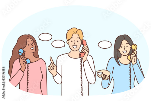 Smiling diverse people talk on landline phones