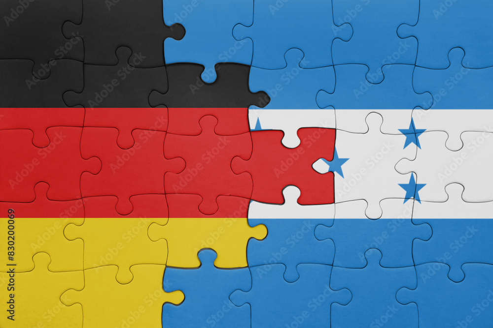 puzzle with the colourful national flag of honduras and flag of germany. puzzle with the colourful national flag of honduras and flag of germany.
