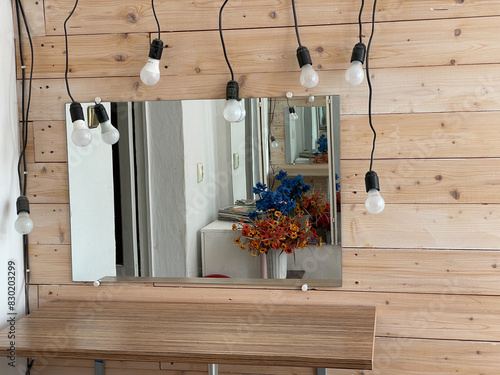 make-up mirror with bulbs and flowers