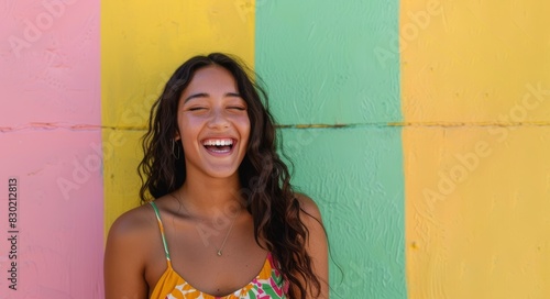 beautiful diverse black woman standing by bright colorful green, yellow, pink wall, smiling and laughing - candid lifestyle daily life moment