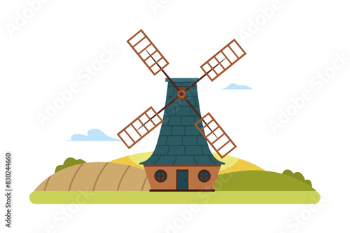 A farm with a classic windmill standing among the fields.