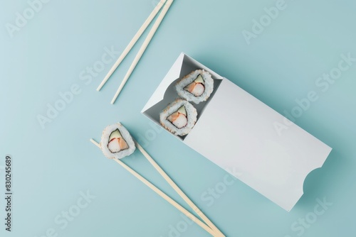 mockup of a white sushi box on a blue background with rolls and chopsticks, branding