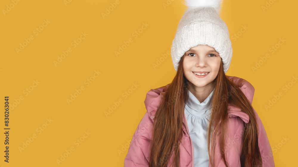 Little girl in padded warm coat. Seasonal fashion. Winter holidays. Fashion child winter clothes. Kid wear hat and jacket yellow background. Little girl in padded warm coat. Seasonal fashion. Winter holidays. Fashion child winter clothes. Kid wear hat and jacket yellow background.