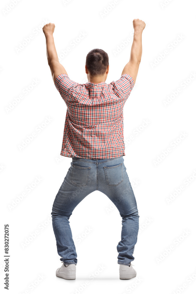 Rear view shot of a happy young man cheering with arms up Rear view shot of a happy young man cheering with arms up