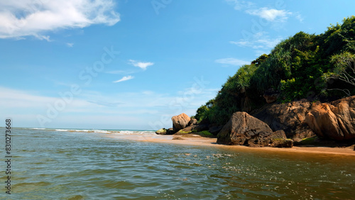 Bild auf Leinwand Paradise coastline with rocks and soft sandy beach, lush green forests