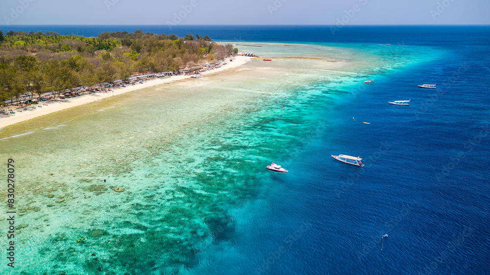 Obraz premium Aerial view of a fringing coral reef and warm, tropical ocean