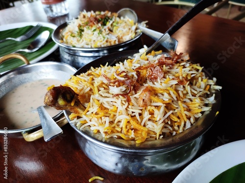 Indian cuisine - Kolkata biryani made with basmati rice, chicken, boiled egg and potato. photo