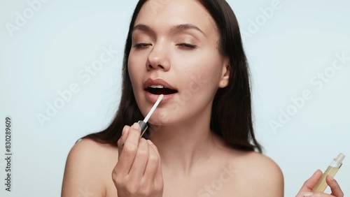 Wallpaper Mural A young female delicately applies lip balm on her lips as part of her daily beauty regimen for lip care and hygiene Torontodigital.ca