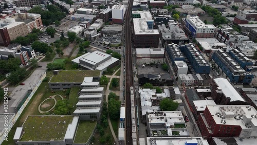 The photo captures a vibrant scene in Fishtown, Philadelphia, with the elevated Market-Frankford Line train  photo