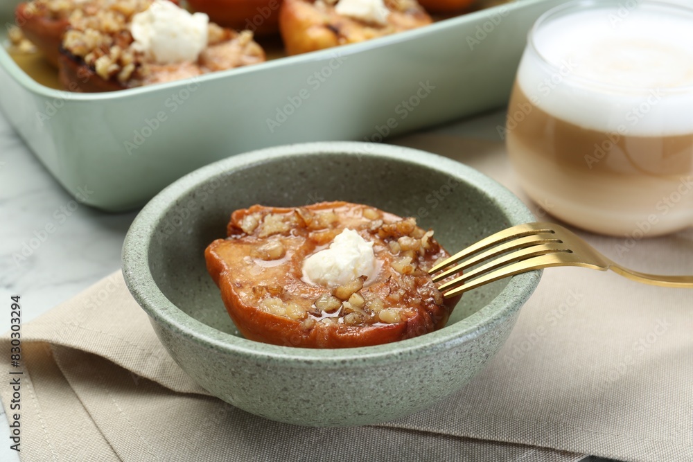 Tasty baked quinces with nuts and cream cheese served on table Tasty baked quinces with nuts and cream cheese served on table