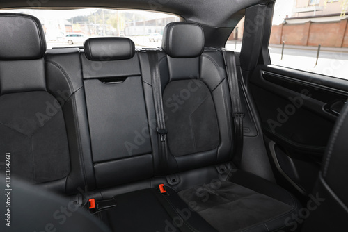 Clean leather seats inside of modern black car © New Africa