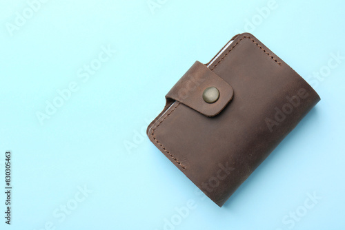 Stylish leather card holder on light blue background, top view. Space for text