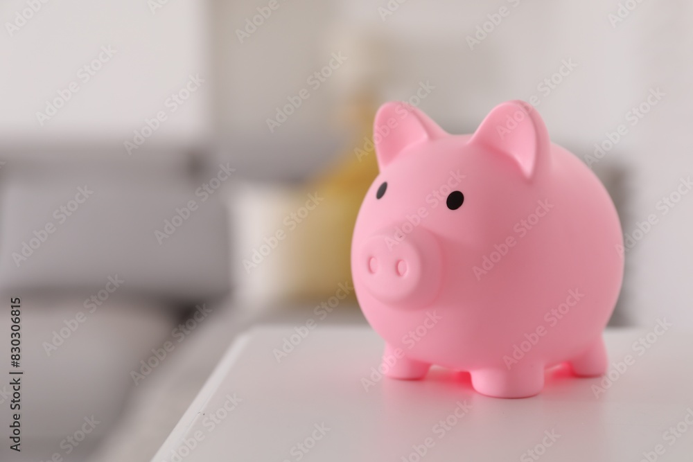 Pink piggy bank on white table, space for text Pink piggy bank on white table, space for text