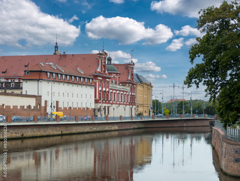 Summer cityscape of Wrocław, Poland: View of Grodzka street at the Oder river and Ossolineum (Ossoliński National Institute, Polish: Zakład Narodowy im. Ossolińskich, ZNiO)