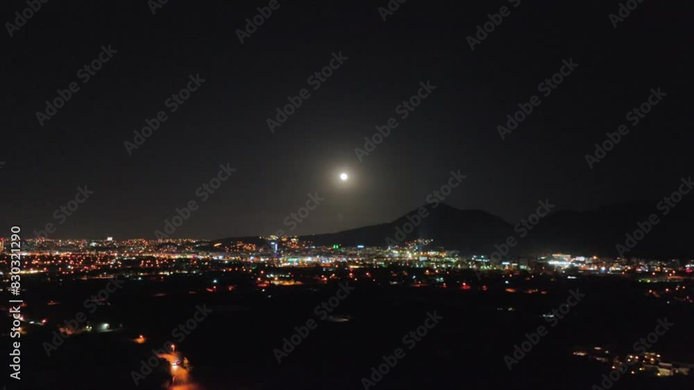 Aerial view of night city with moonlight landscape
