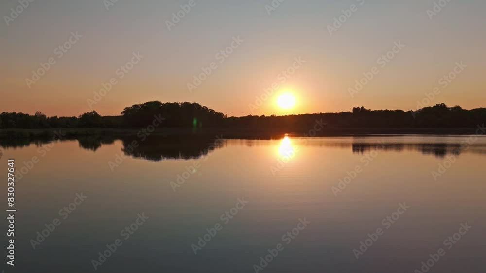 Scenic view of the forest lake at sunset in the wilderness Scenic view of the forest lake at sunset in the wilderness