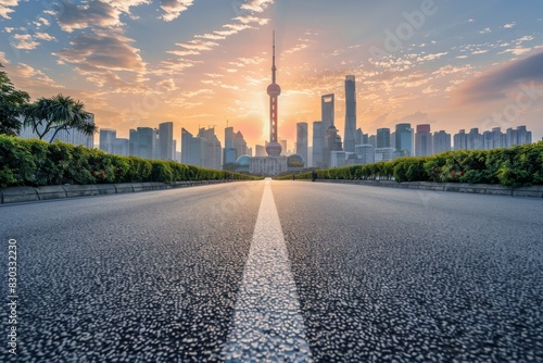 Straight asphalt road and modern city skyline with buildings in Guangzhou at sunset China.  photo