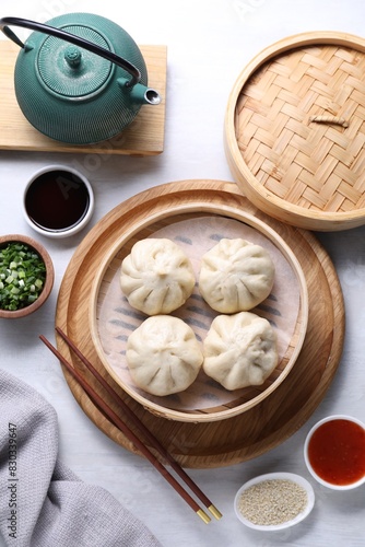 Wallpaper Mural Delicious bao buns (baozi), chopsticks, sauces, seasonings and kettle on light table, flat lay Torontodigital.ca