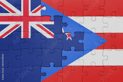 puzzle with the colourful national flag of puerto rico and flag of new zealand.