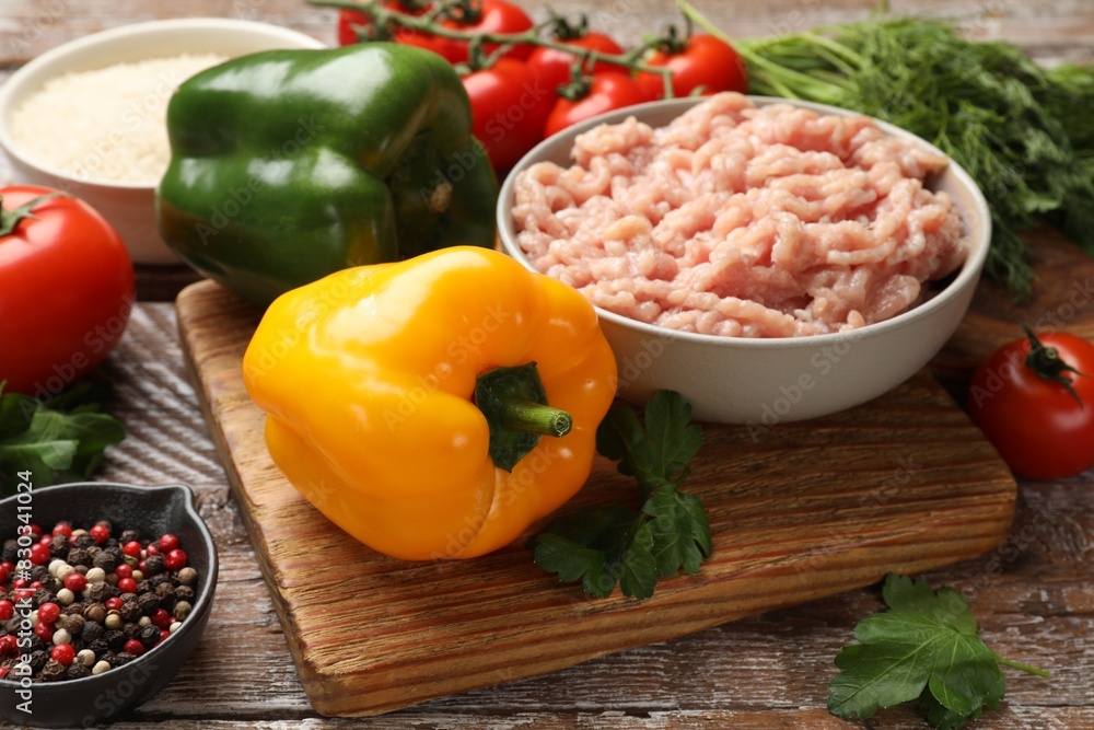 Making stuffed peppers. Ground meat and other ingredients on wooden table Making stuffed peppers. Ground meat and other ingredients on wooden table