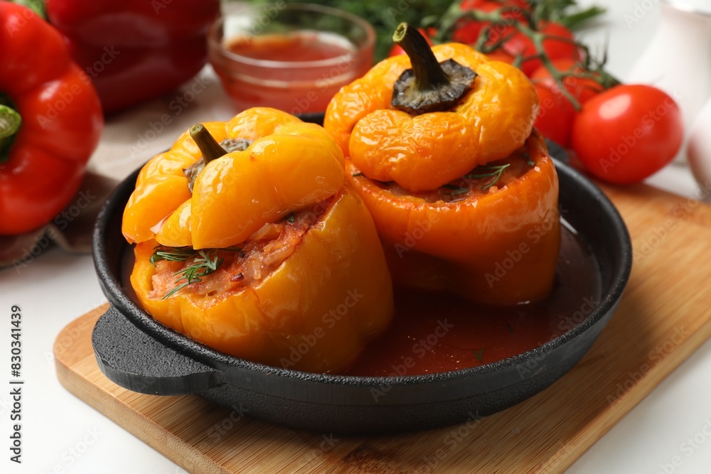 Tasty stuffed peppers in pan on light table, closeup Tasty stuffed peppers in pan on light table, closeup