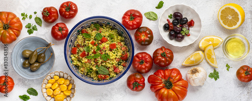 Tabbouleh o tabulè salad,  Arab dish from the Middle East nd  Mediterranean, with parsley, bulgur, onions, mint,   tomatoes, seasoned with lemon juice, olive oil. Tradition Arab plate, banner
 photo
