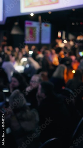 Wallpaper Mural A blurry footage showing a crowd sitting in a dark room at an event Torontodigital.ca