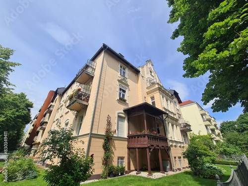 wonderful appartement block with unusual architecture, trees and sky in Berlin Wilmersdorf (Germany, Europe), for renting and gentrification topics photo