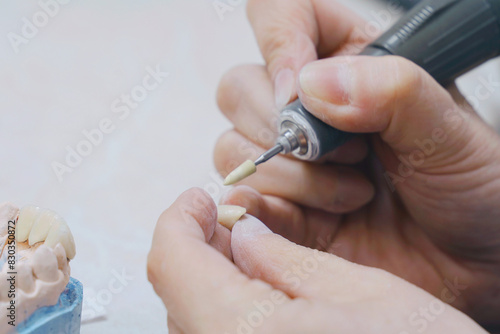 Person Cutting Tooth With Scissors