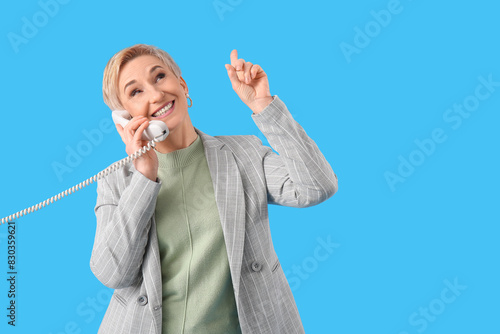 Mature woman talking by tel...