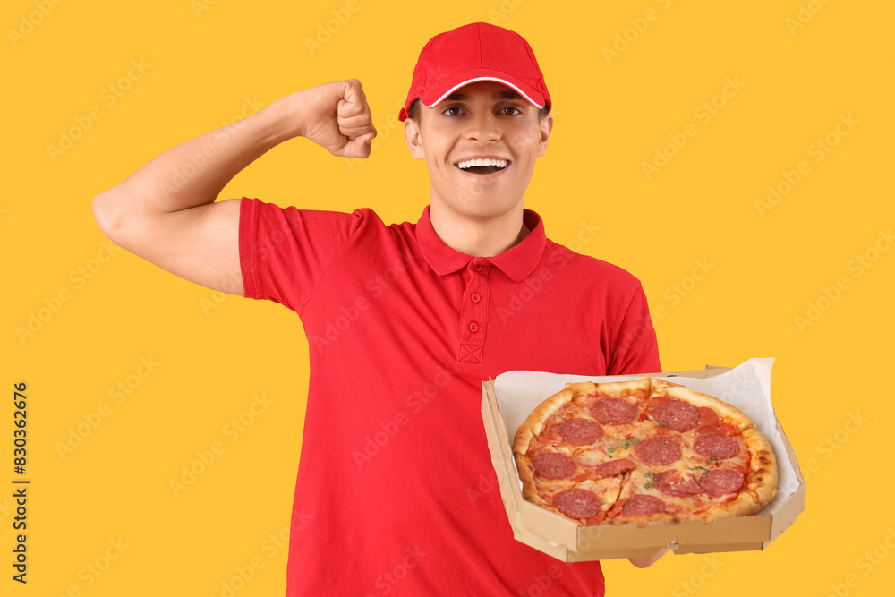 Male courier with tasty pepperoni pizza on yellow background Male courier with tasty pepperoni pizza on yellow background